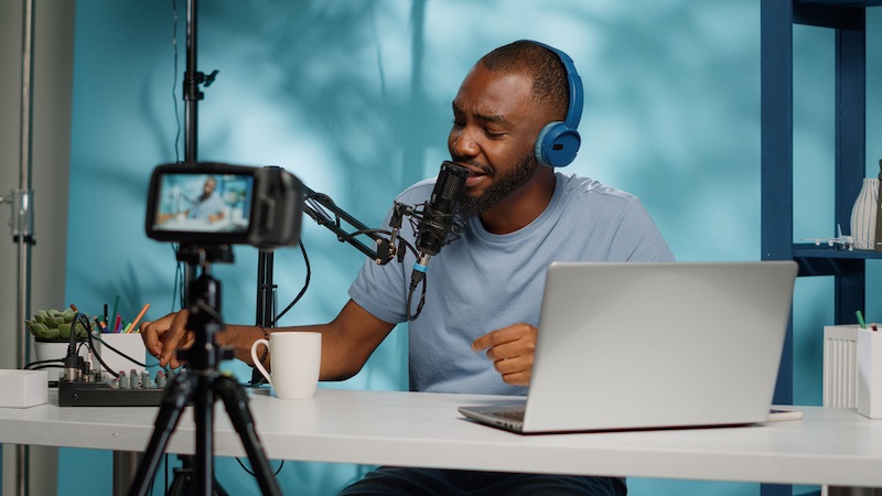 Influencer using podcast equipment and headphones